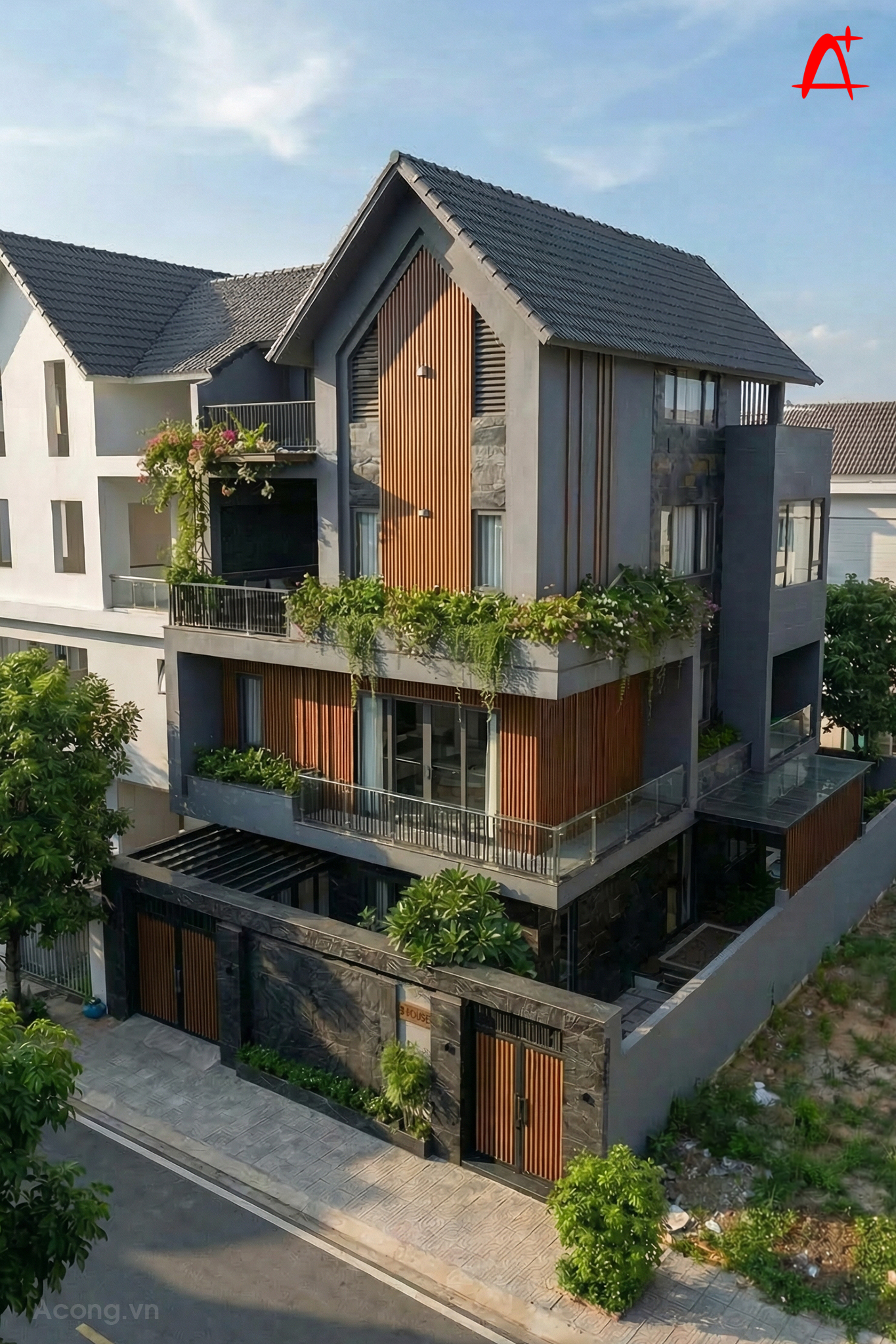 To&agrave;n cảnh biệt thự phố 3 tầng nh&igrave;n từ tr&ecirc;n cao, nổi bật với m&aacute;i dốc kiến tr&uacute;c, s&acirc;n thượng rộng v&agrave; hệ c&acirc;y xanh bao quanh c&ocirc;ng tr&igrave;nh.